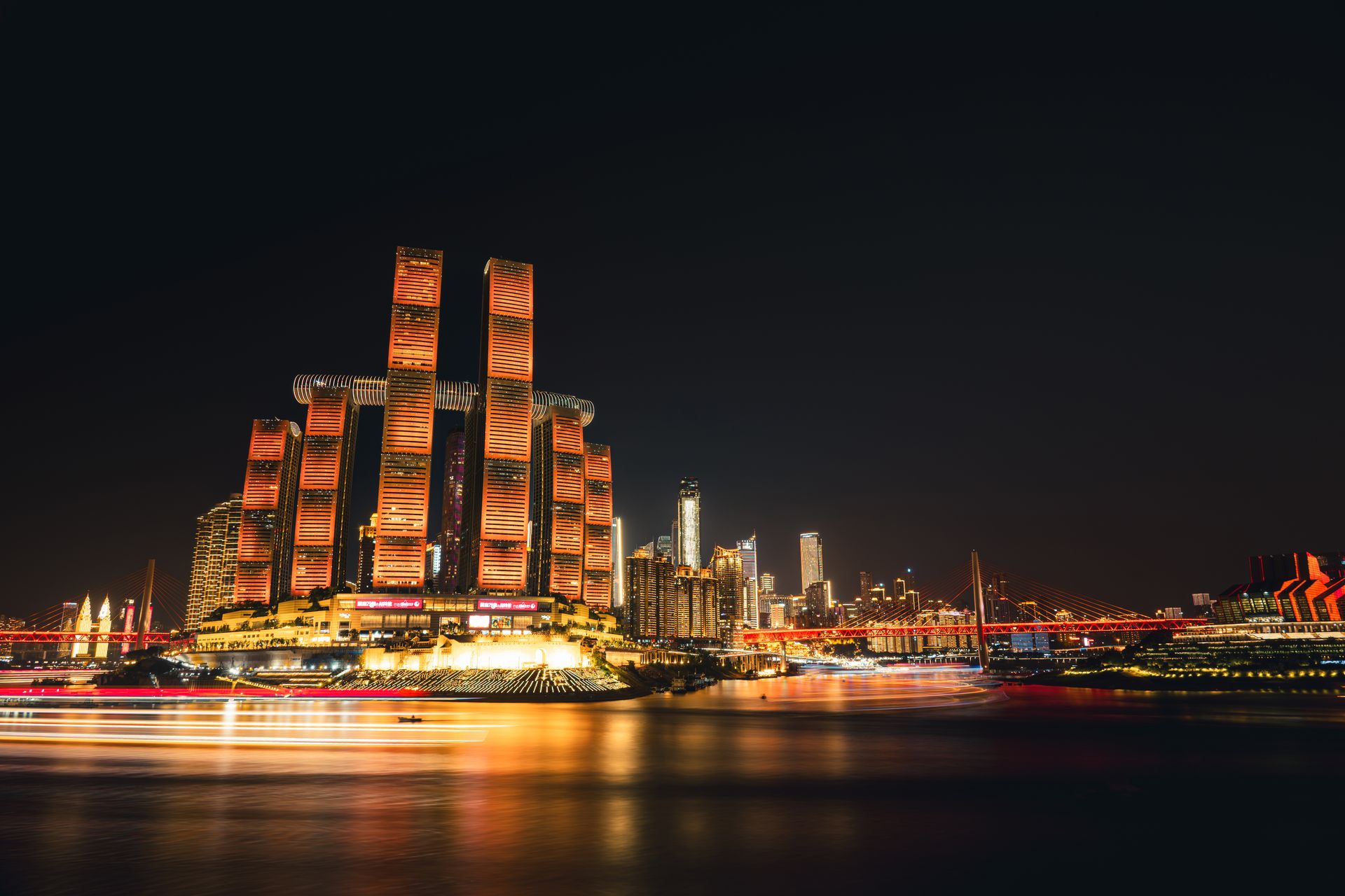 Chongqing’s illuminated skyline beside the river at night